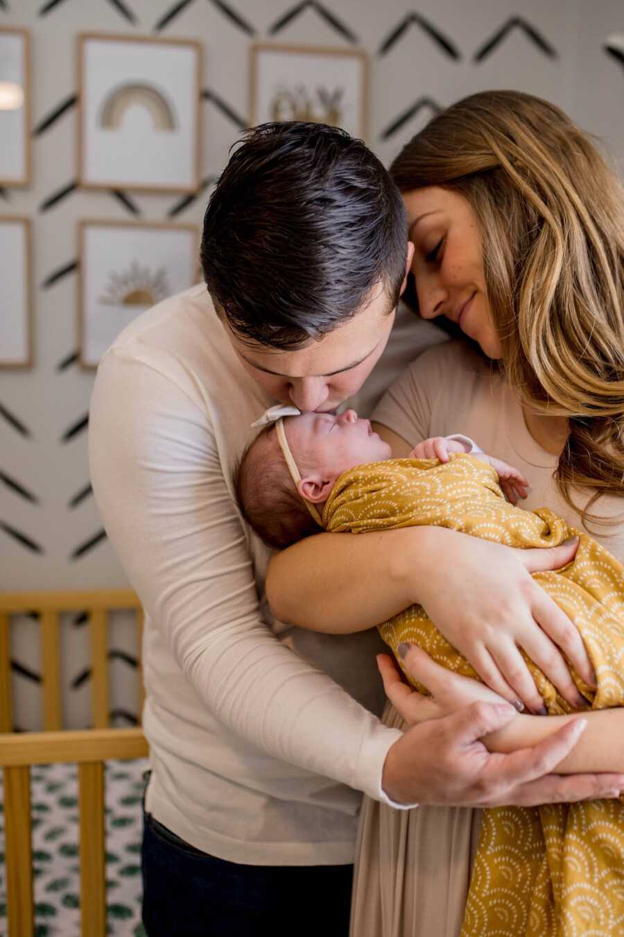 husband, wife and rainbow baby