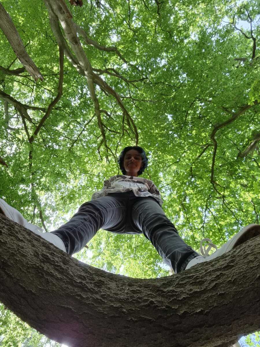 woman on a tree looking at the camera