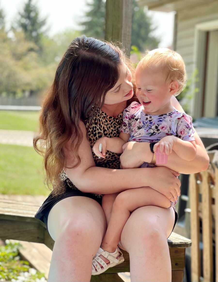 mom kissing her daughter