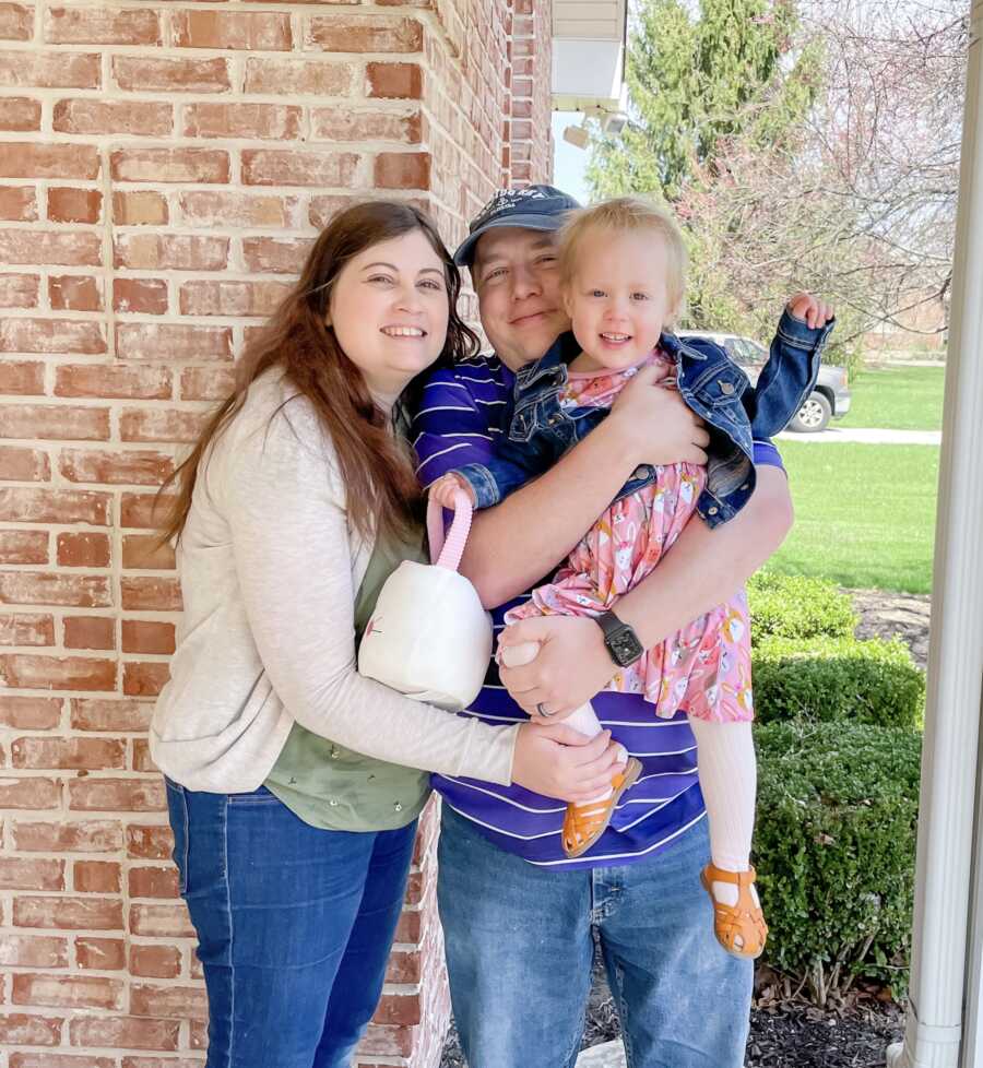 cute family photo outside with an Easter basket