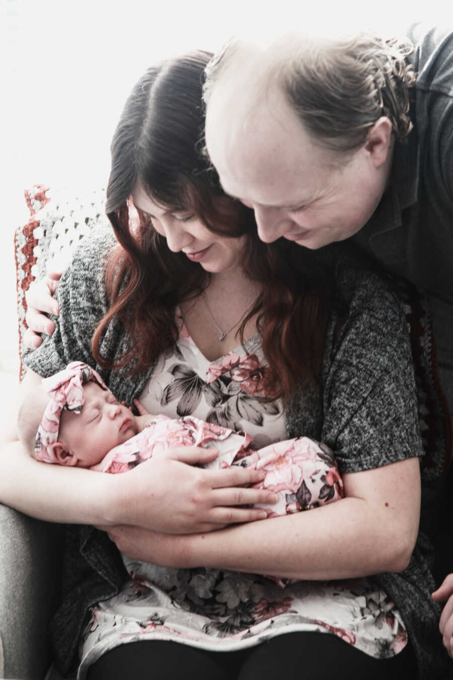 mom and dad admiring daughter