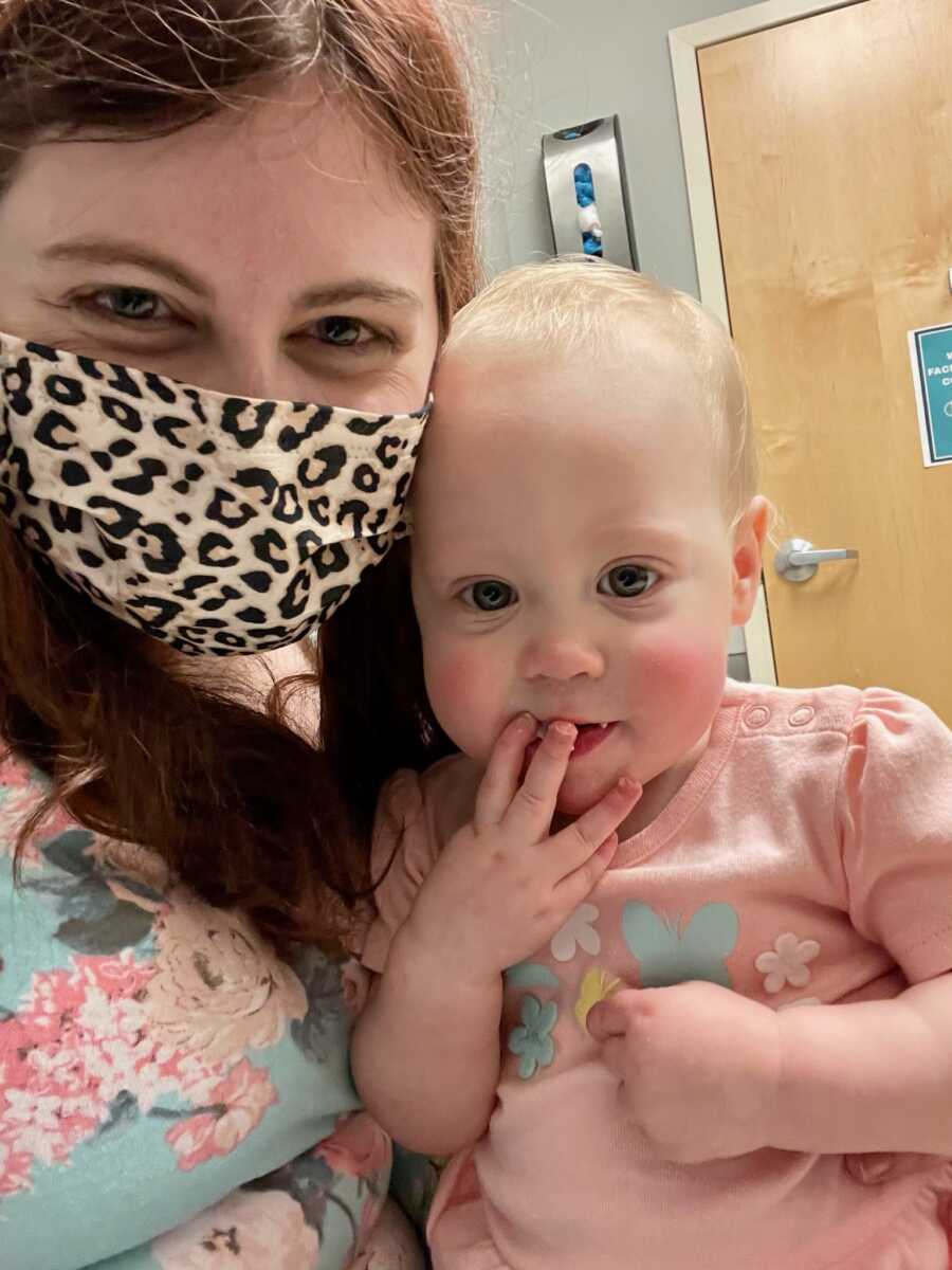 mom wearing a mask with her daughter at the doctor