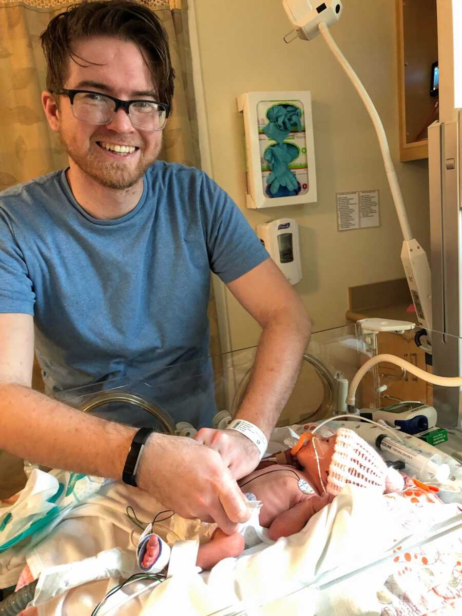 Father with his newborn daughter in NICU