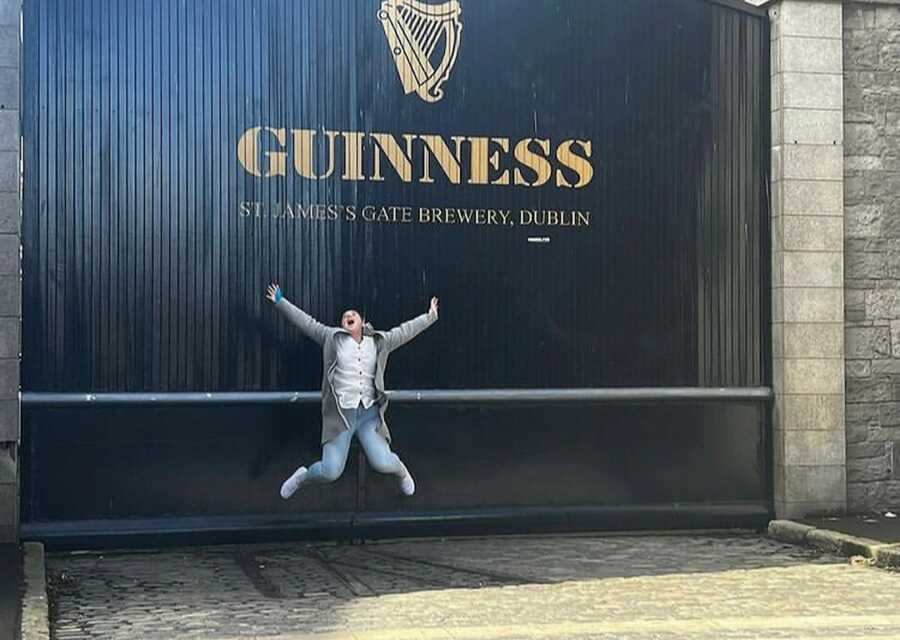 woman jumping in front of building 