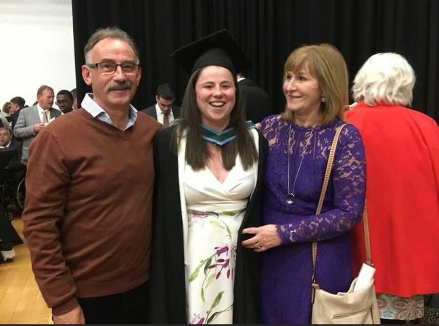 mother father and daughter at graduation 