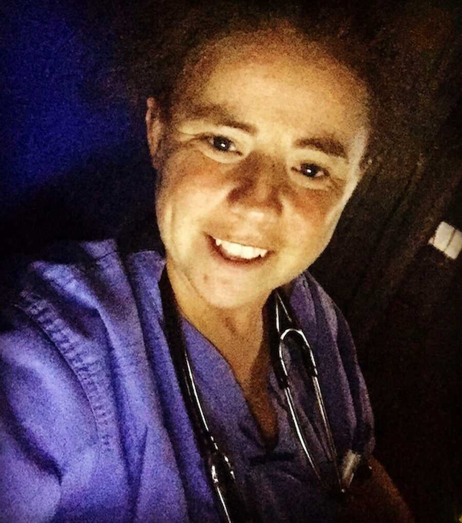 woman in scrubs smiling