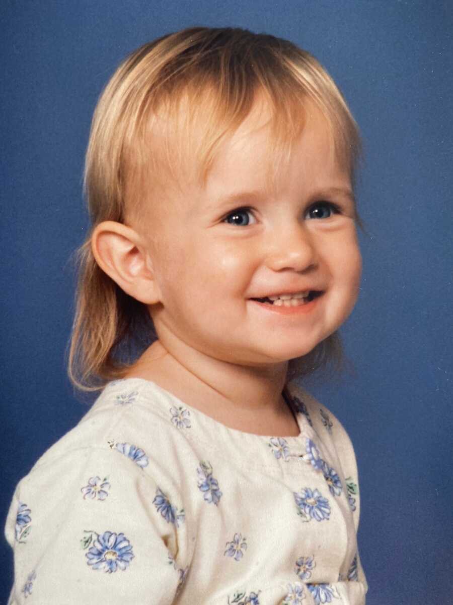 Young blonde girl smiling