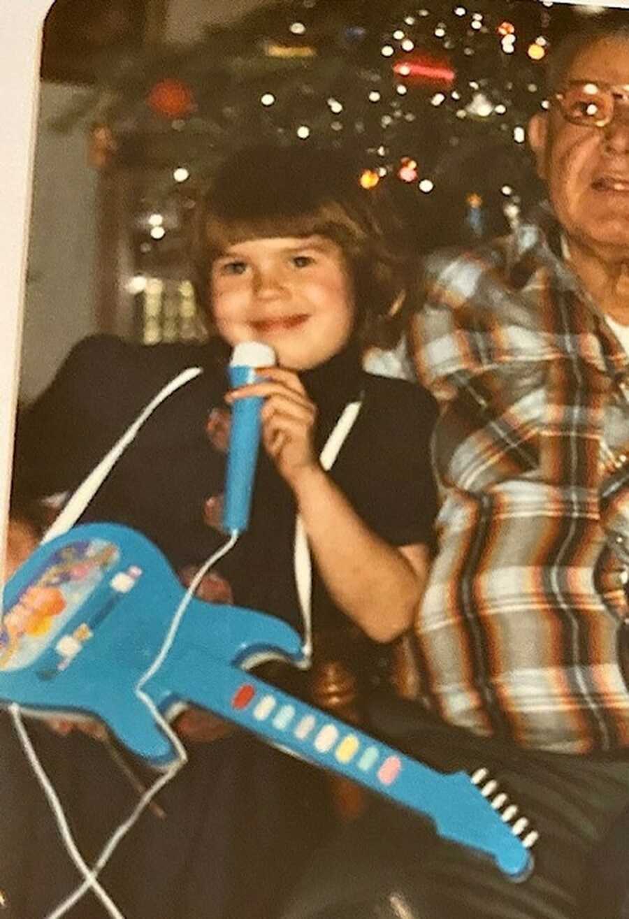 young girl with guitar and microphone