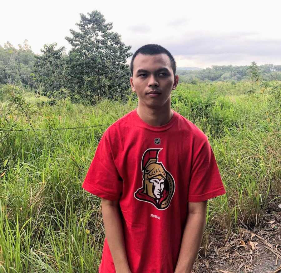 man with cerebral palsy in front of grass