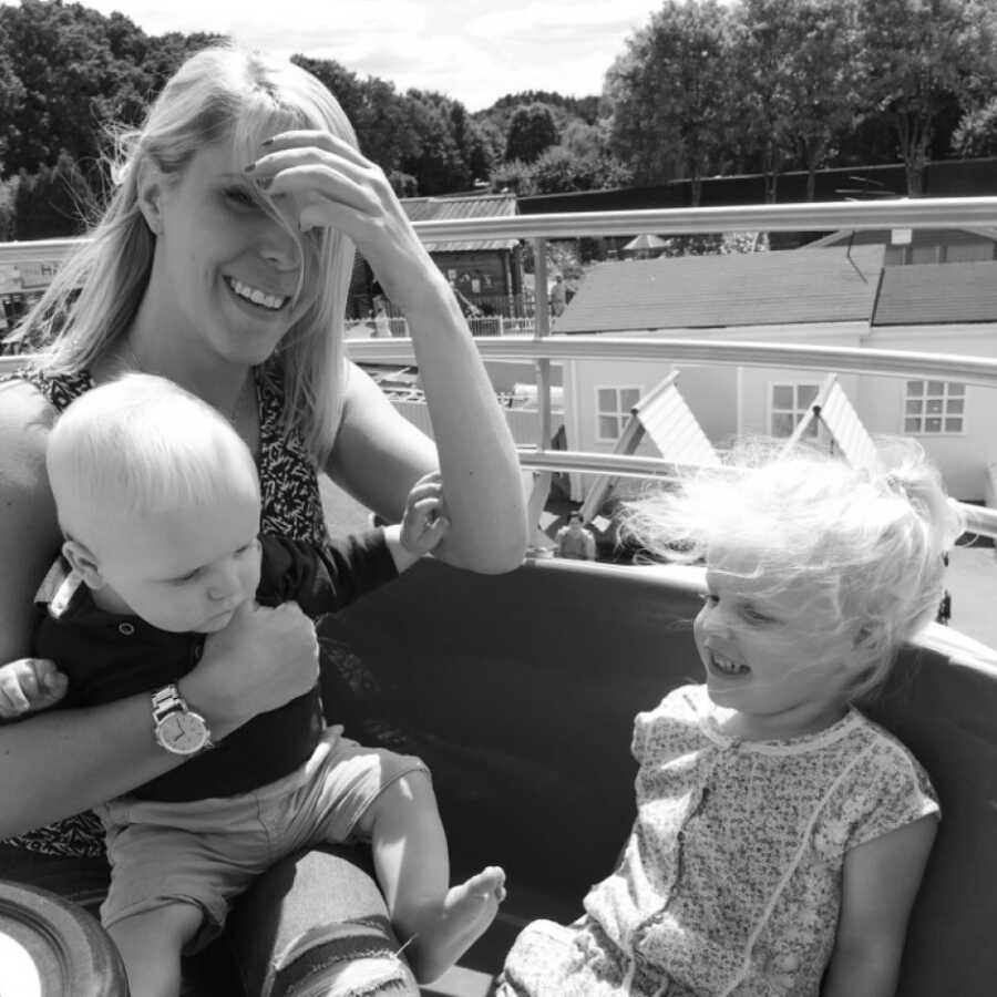 mom and her kids on a bus smiling