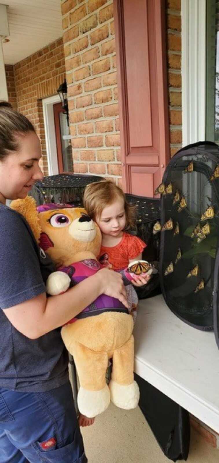 little girl holding butterfly