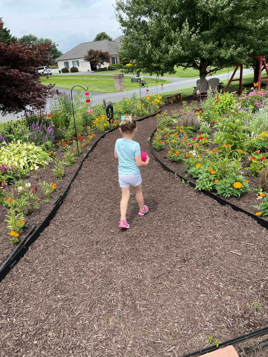 grandchild walking through plants