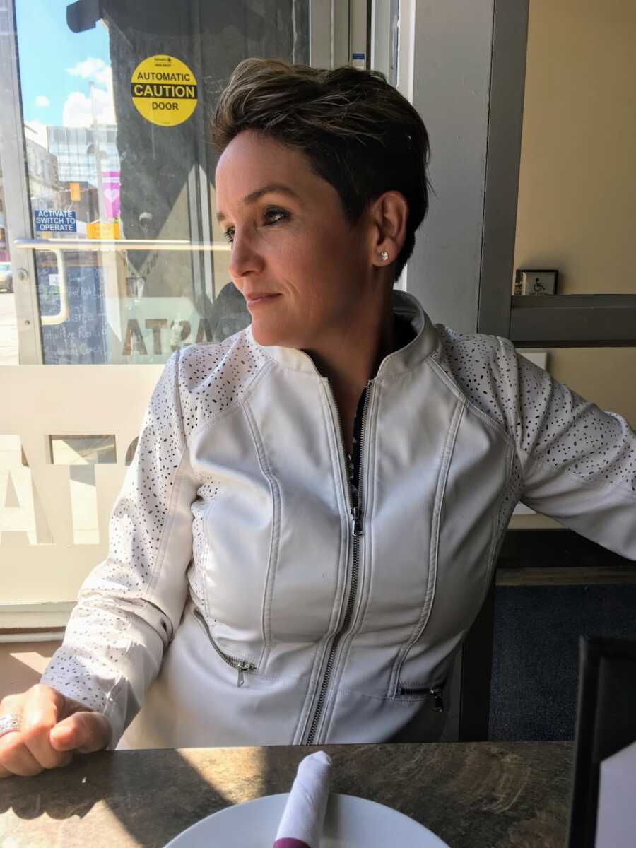 Woman sitting by window in a cafe