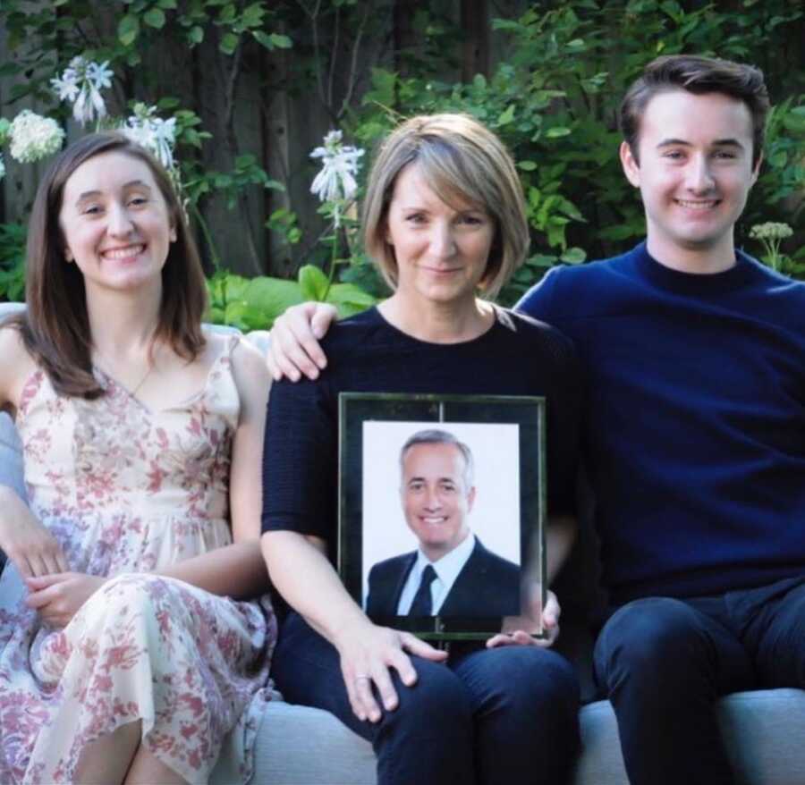 woman with two children and photo of late husband