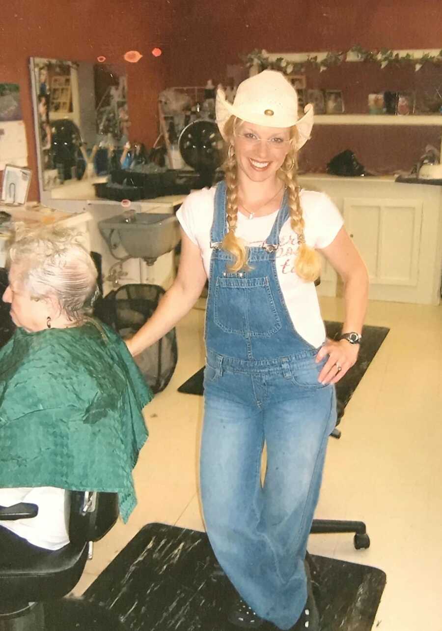 woman standing up at hair salon 