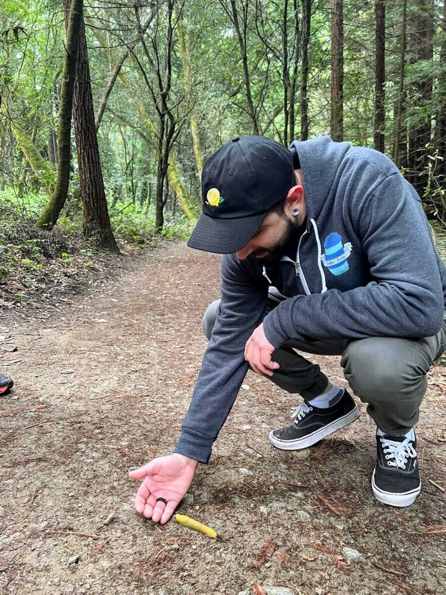 Alcoholic on hiking trail holding out hand for a banana slug