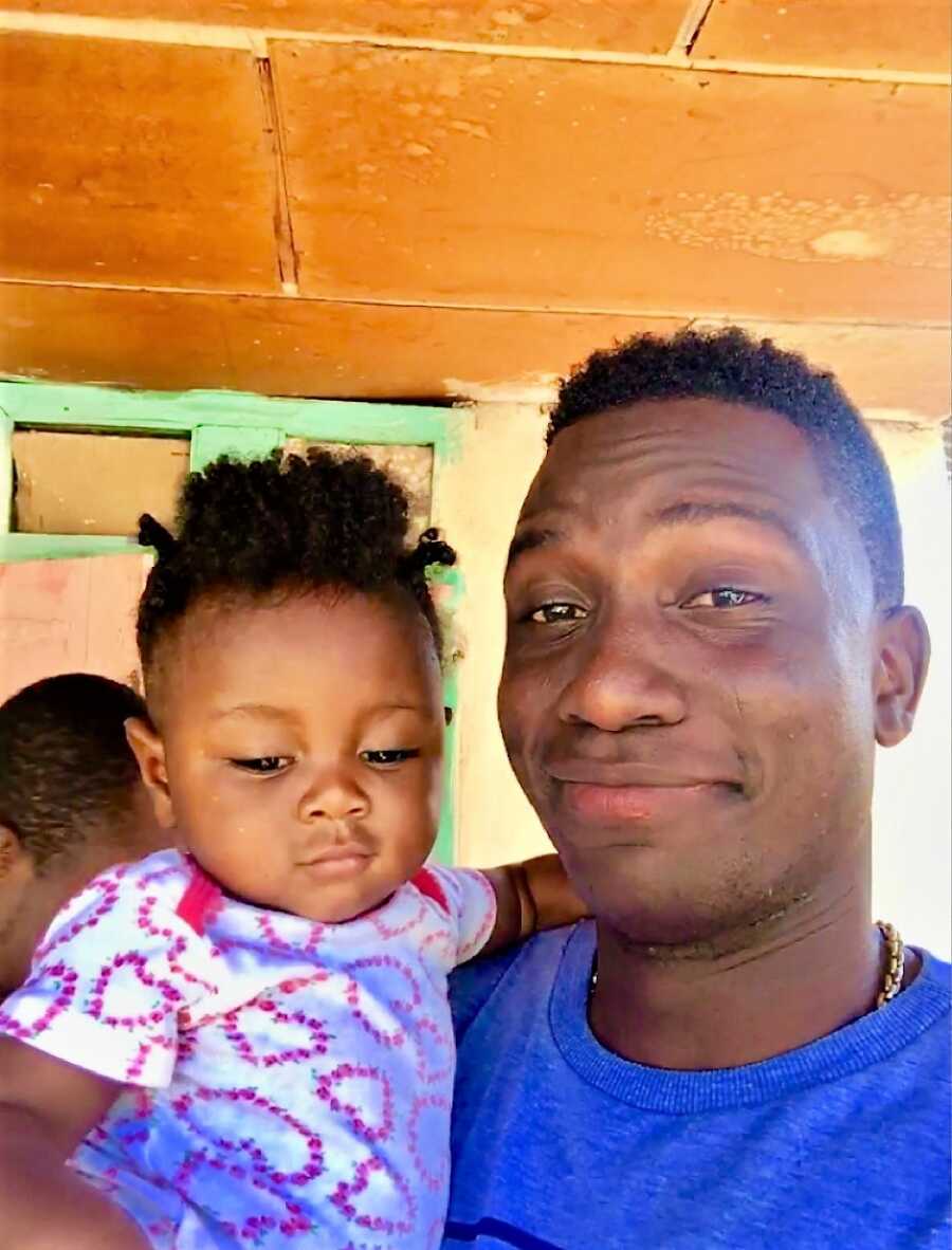 man taking a selfie with his kid who he found in a dumpster