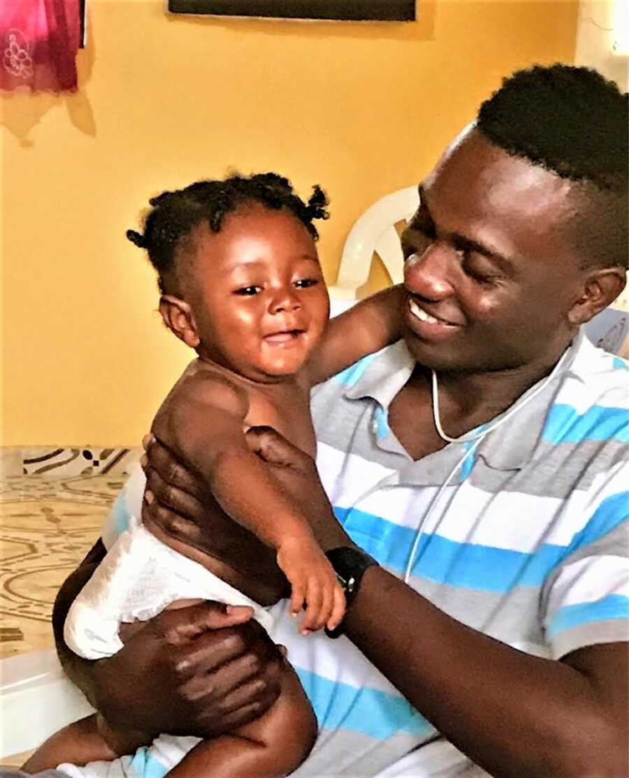 dad holding son while he is laughing