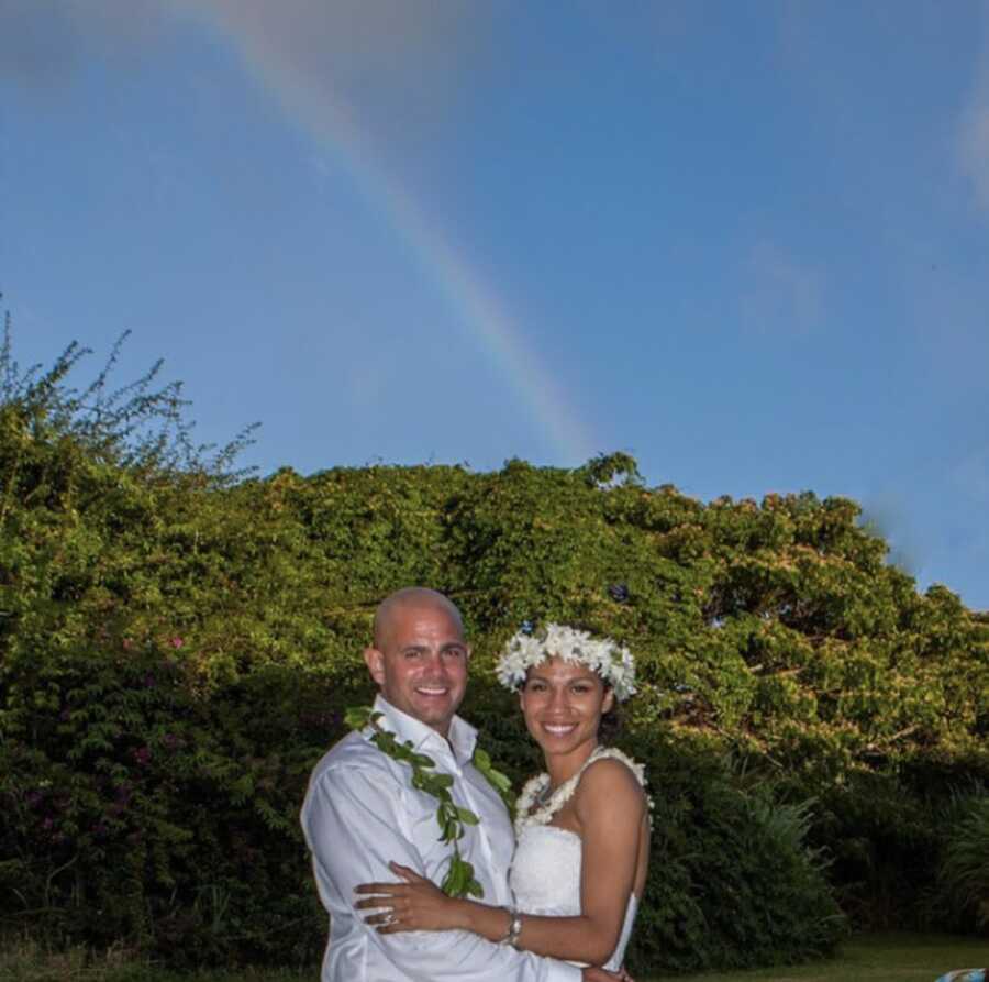 Wedding photo in front of rainbow