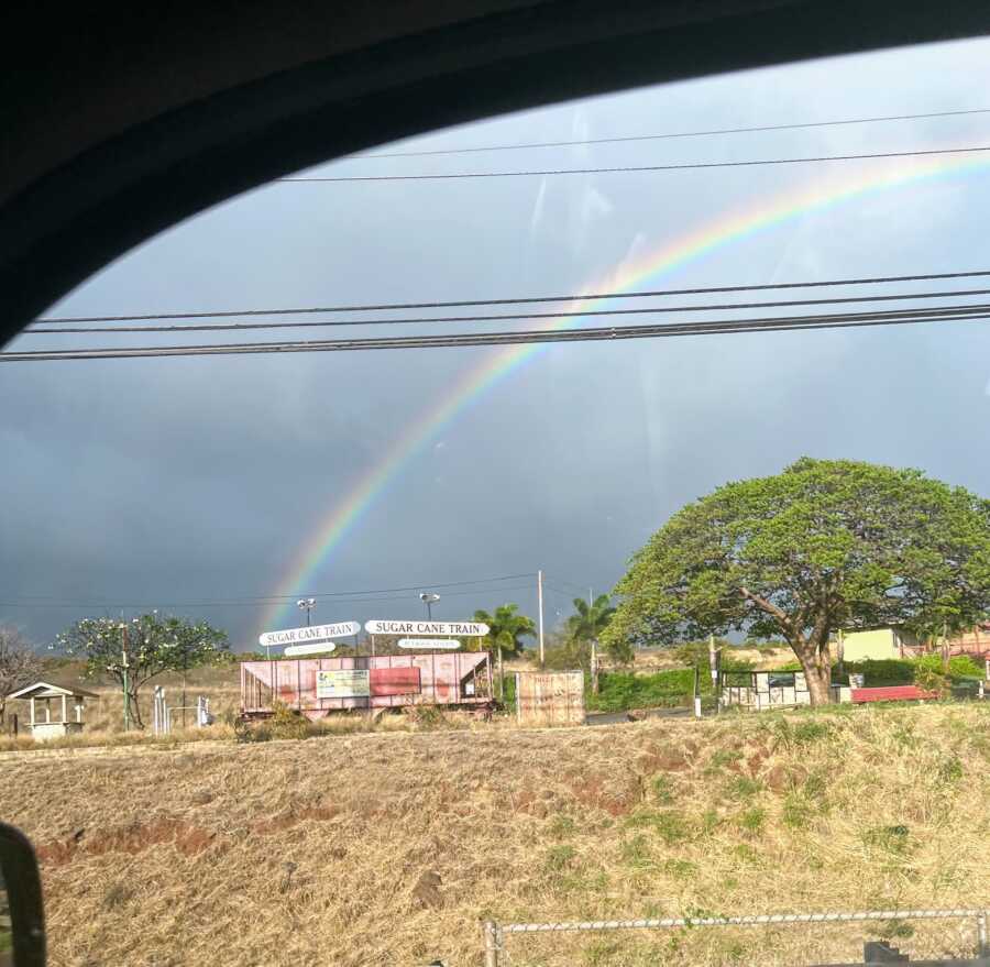 Rainbow seen outside of a car window