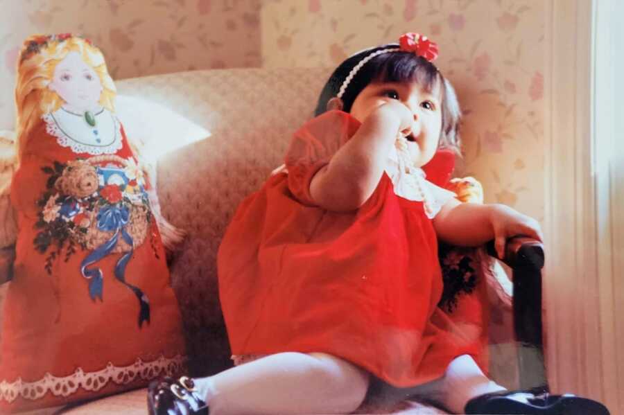 Young adopted girl in red dress