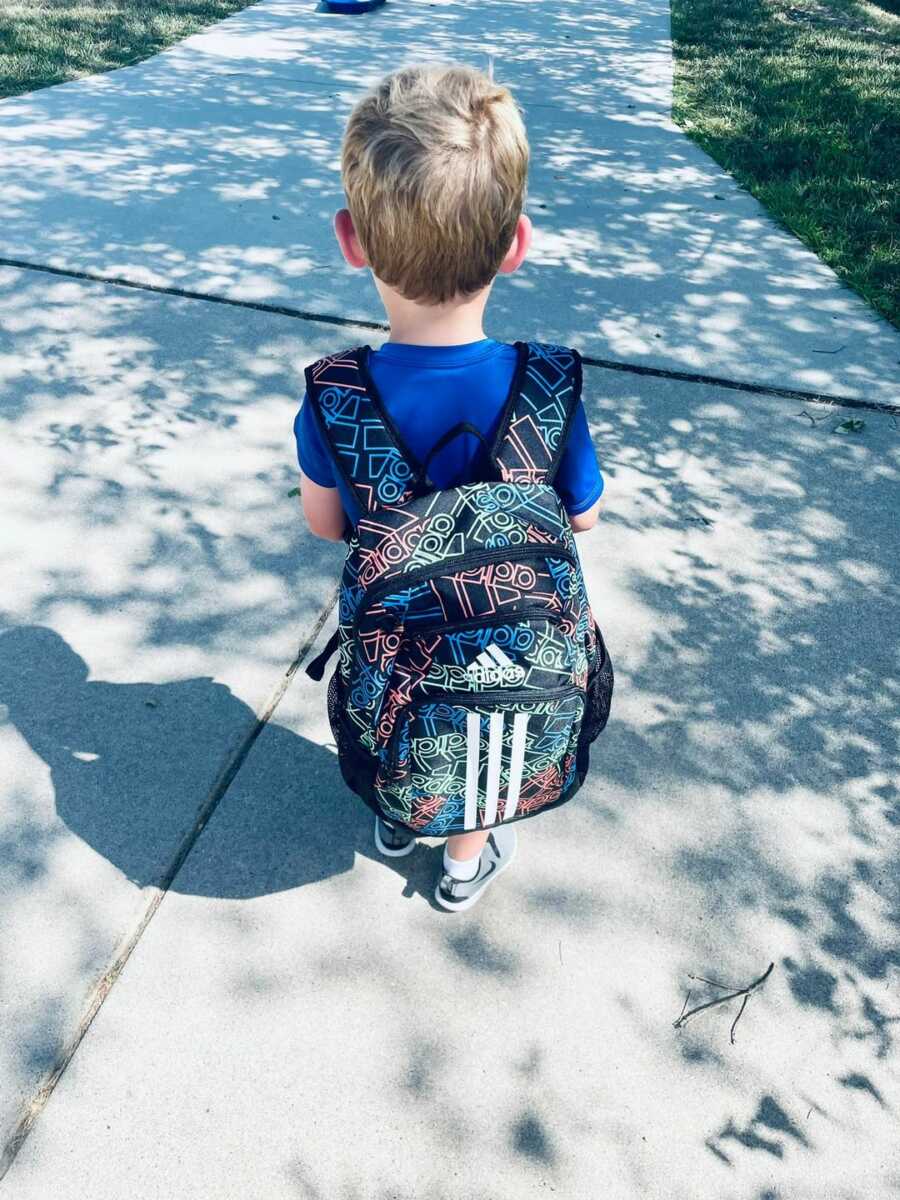 little boy with bookbag on 