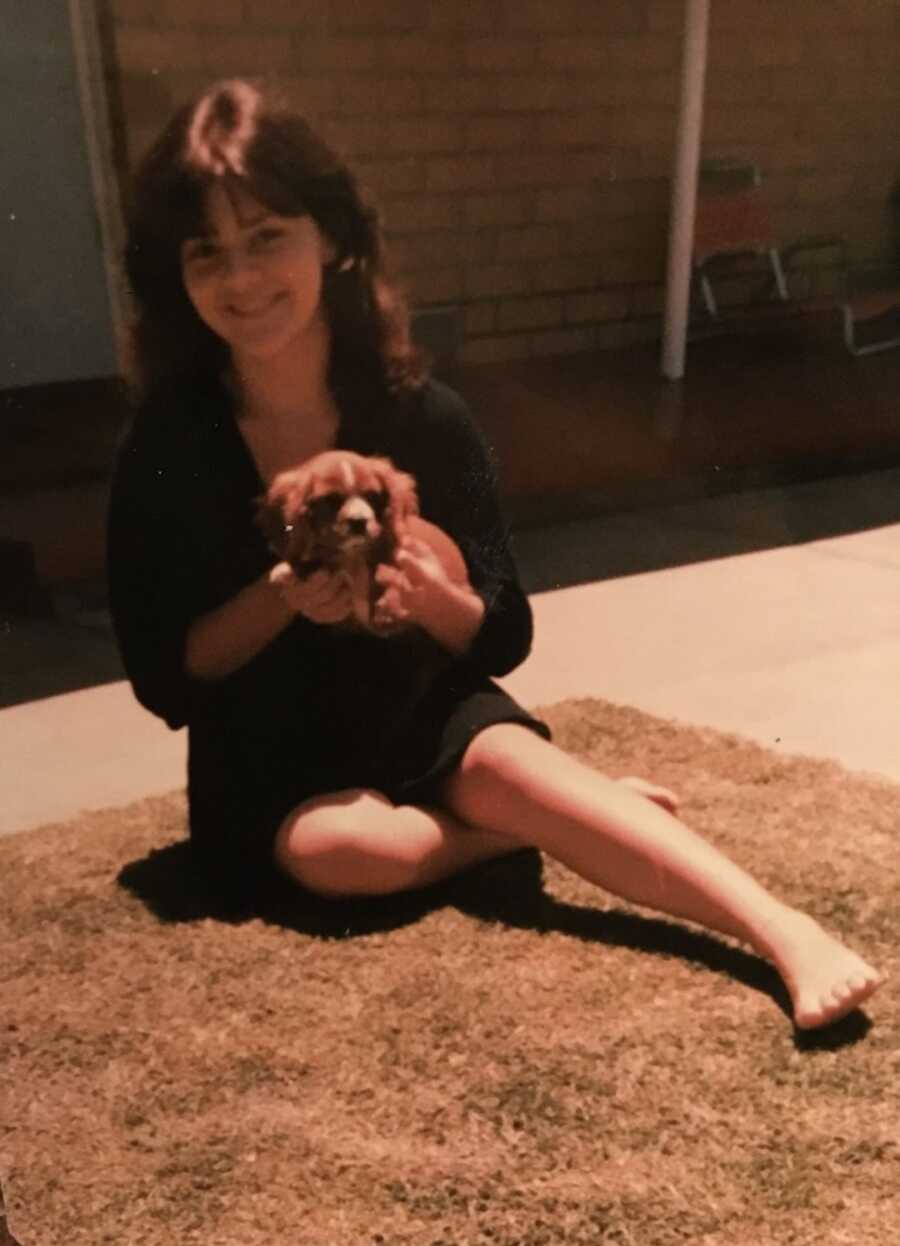 childhood sexual assault survivor holding a puppy