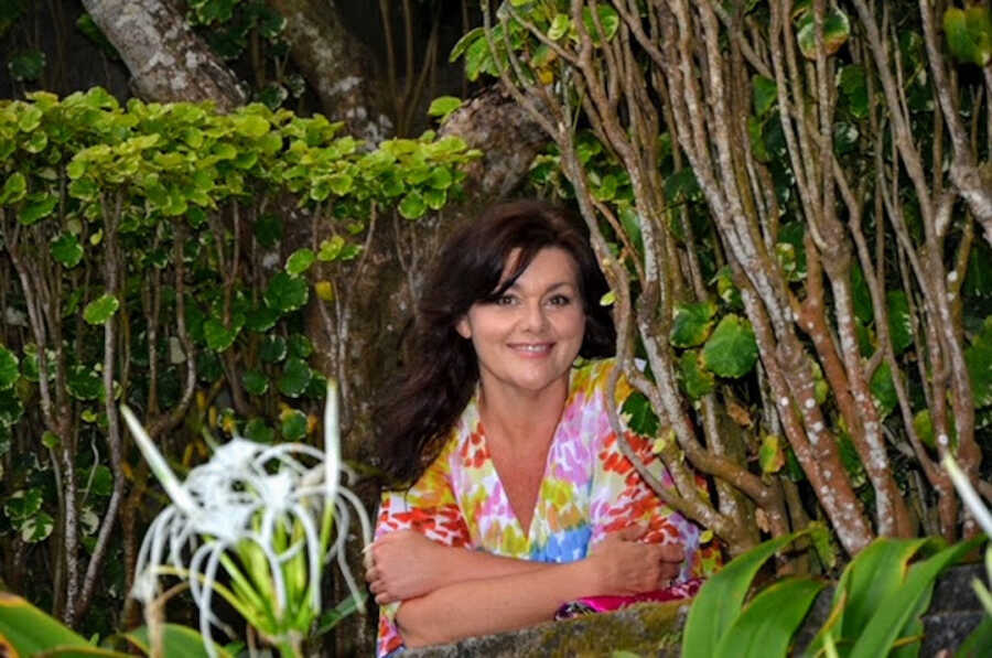 sexual assault survivor in colorful shirt amongst bushes