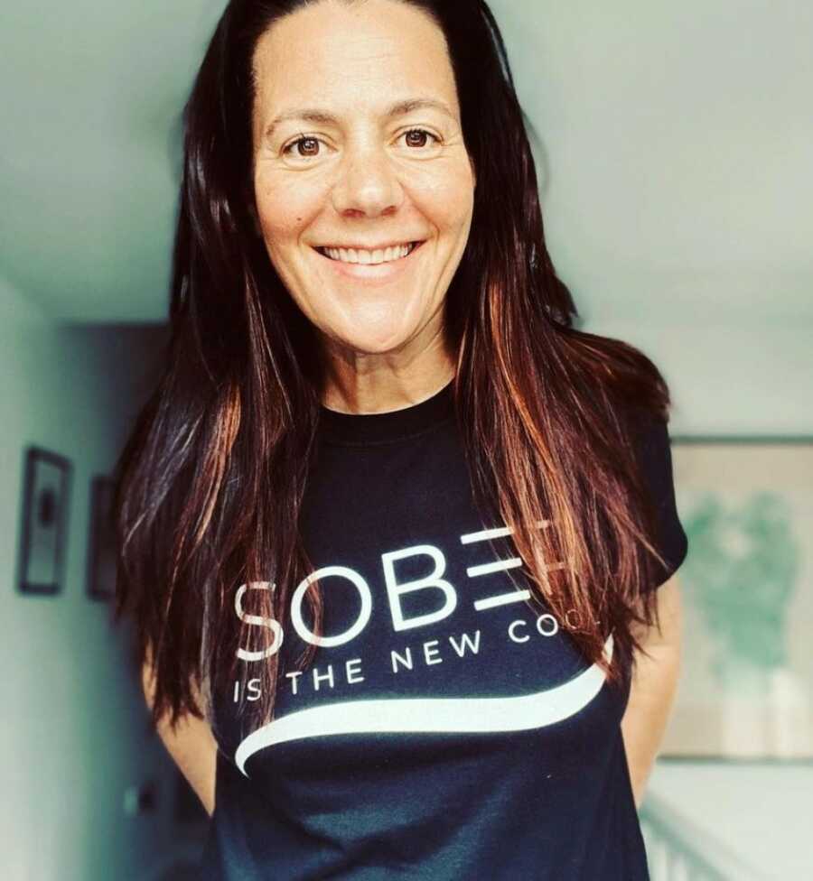 woman showing off her sober shirt