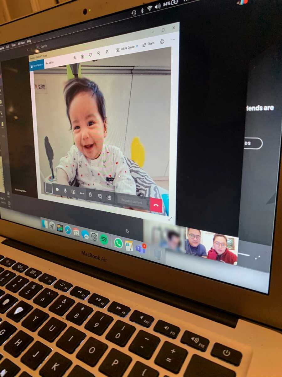 Couple on zoom call looking at photo of future adopted daughter