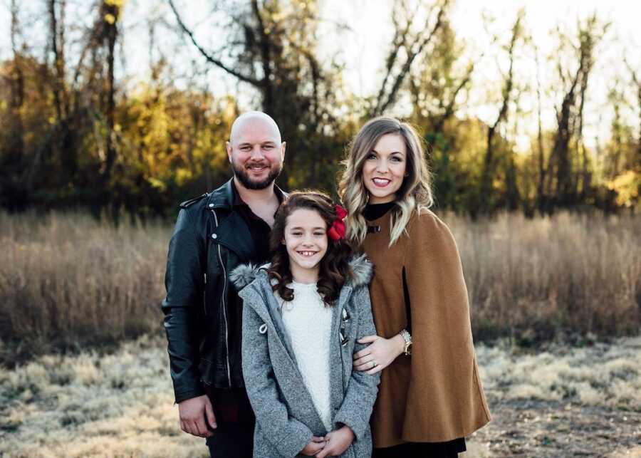 Young couple take family pictures with newly adopted daughter