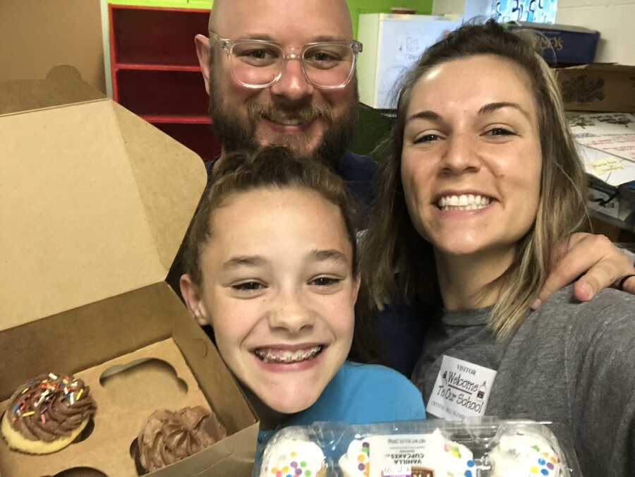 father, mother and daughter with cupcakes 