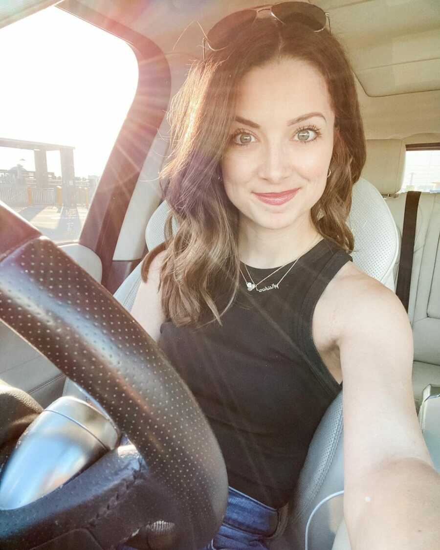 Selfie of young woman in her car