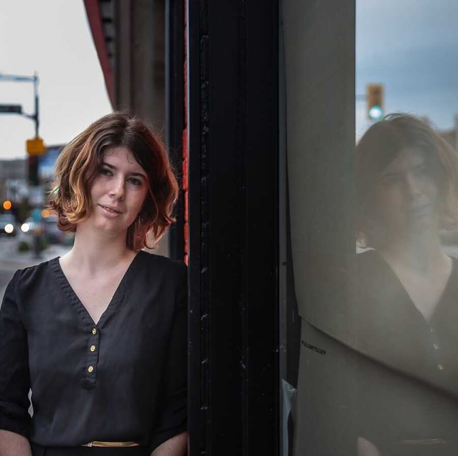 woman standing against building 