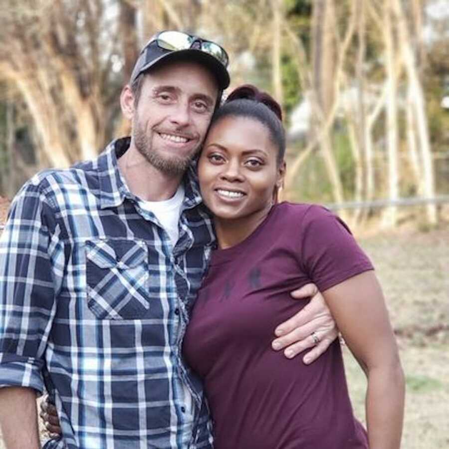 husband and wife smiling