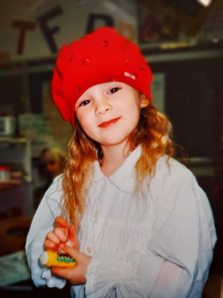 Young redheaded girl with a red hat