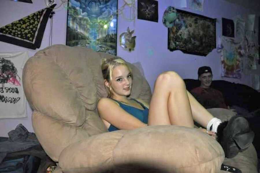 High school drug addict sitting on couch in basement