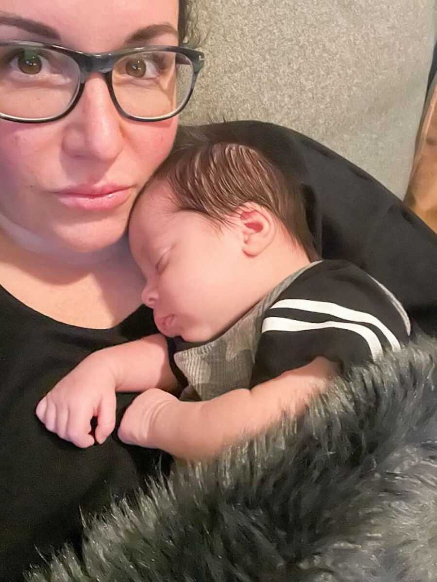 Woman holds newborn baby boy they're adopting