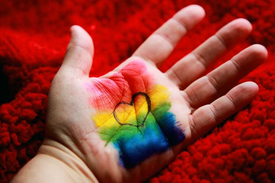 hand with rainbow colors and heart