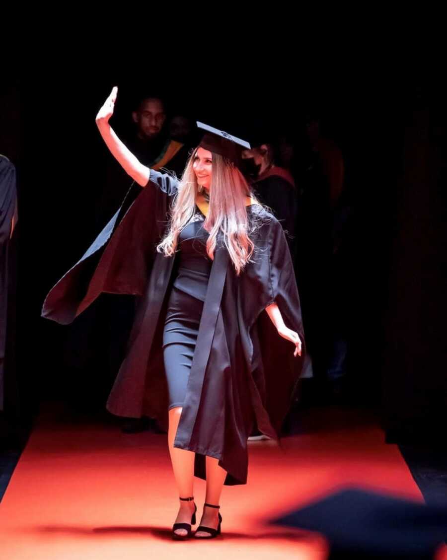 woman walking across the stage