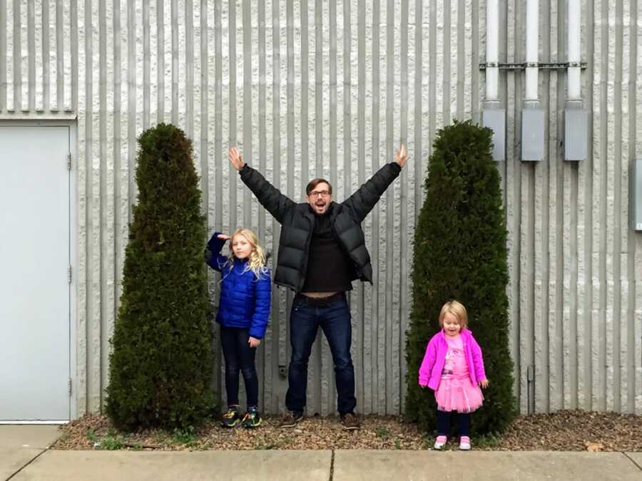 Single father with his two daughters outside