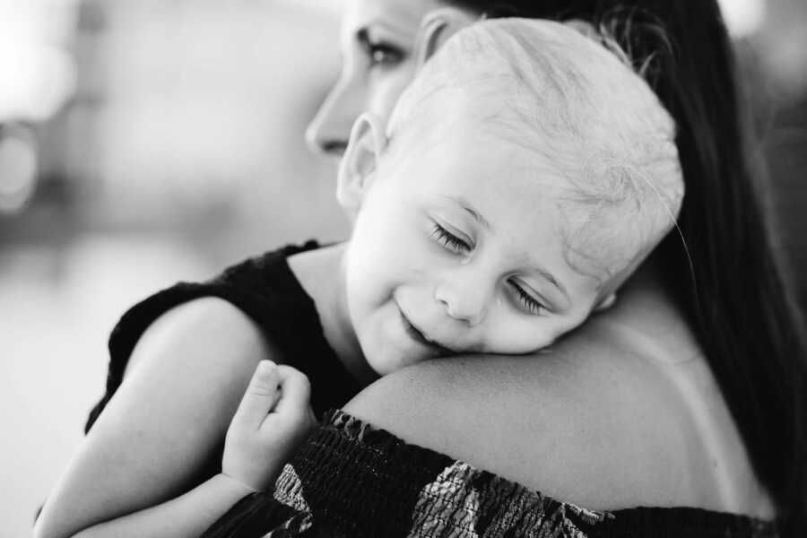 Mother holding daughter in black and white