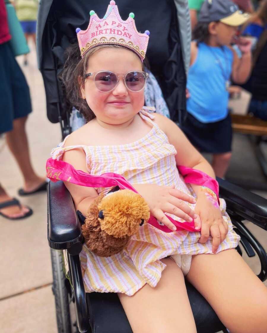 little girl in wheelchair smiling 