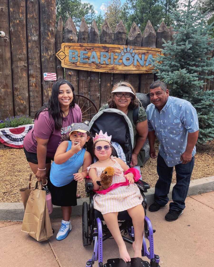 family standing behind and behind young girl 