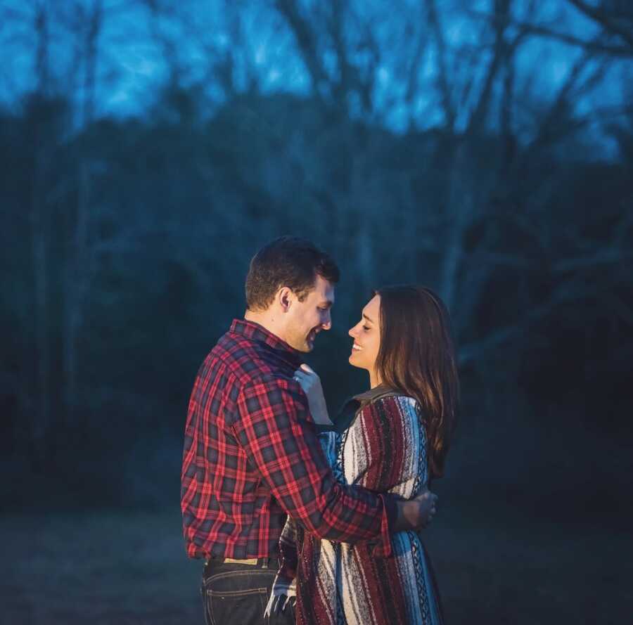 husband and second wife smiling at each other