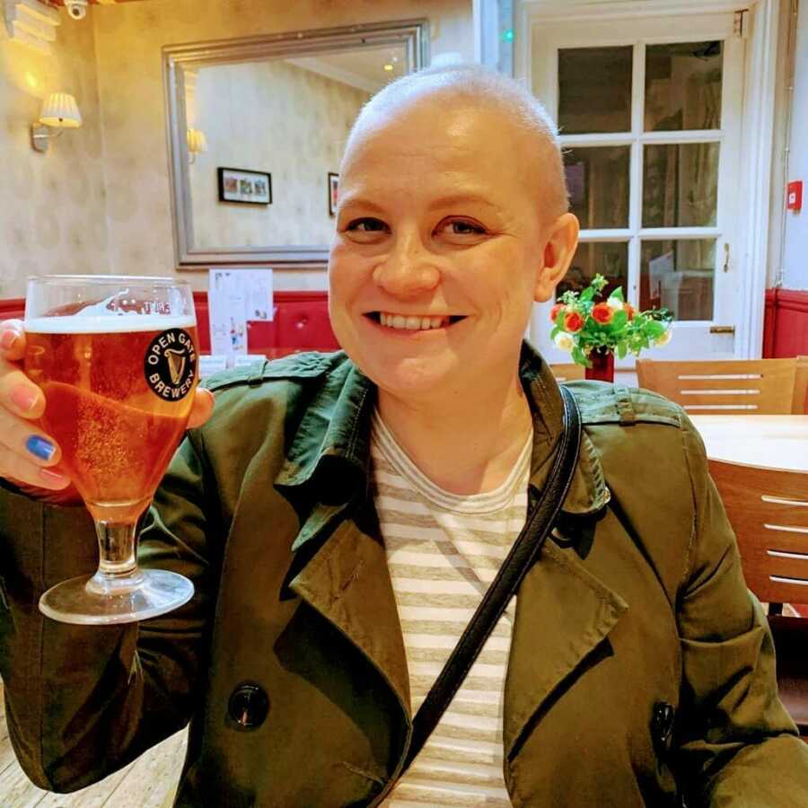 woman with cancer having a beer