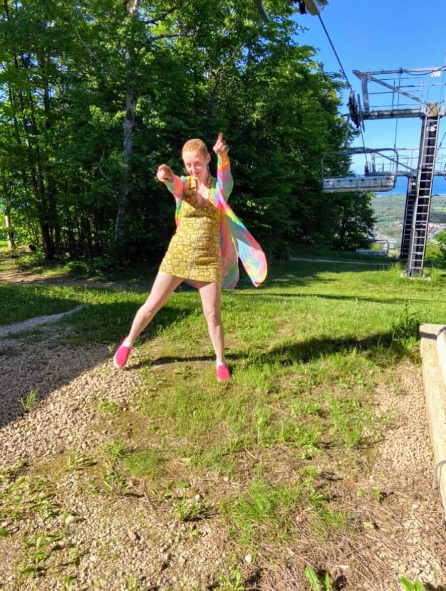 Nonbinary person on hill near ski lift