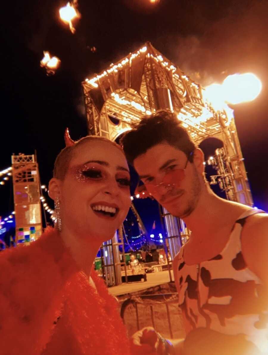 Nonbinary person and their partner at a festival