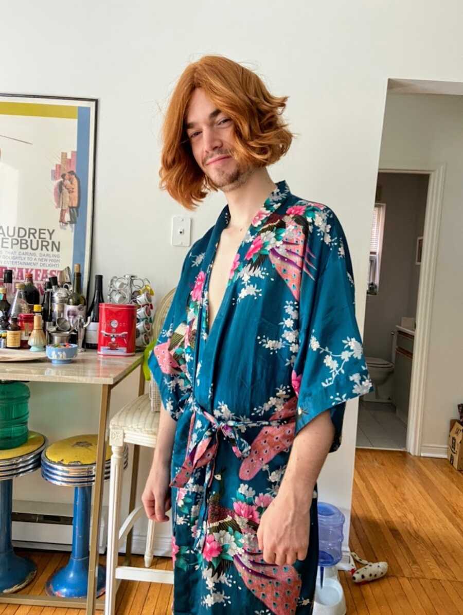 Man in a dressing gown with a wig on