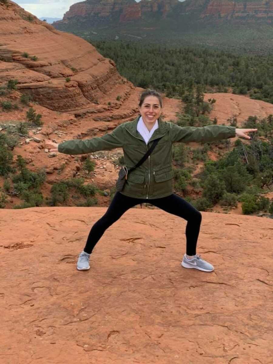 woman posing on top of a canyon